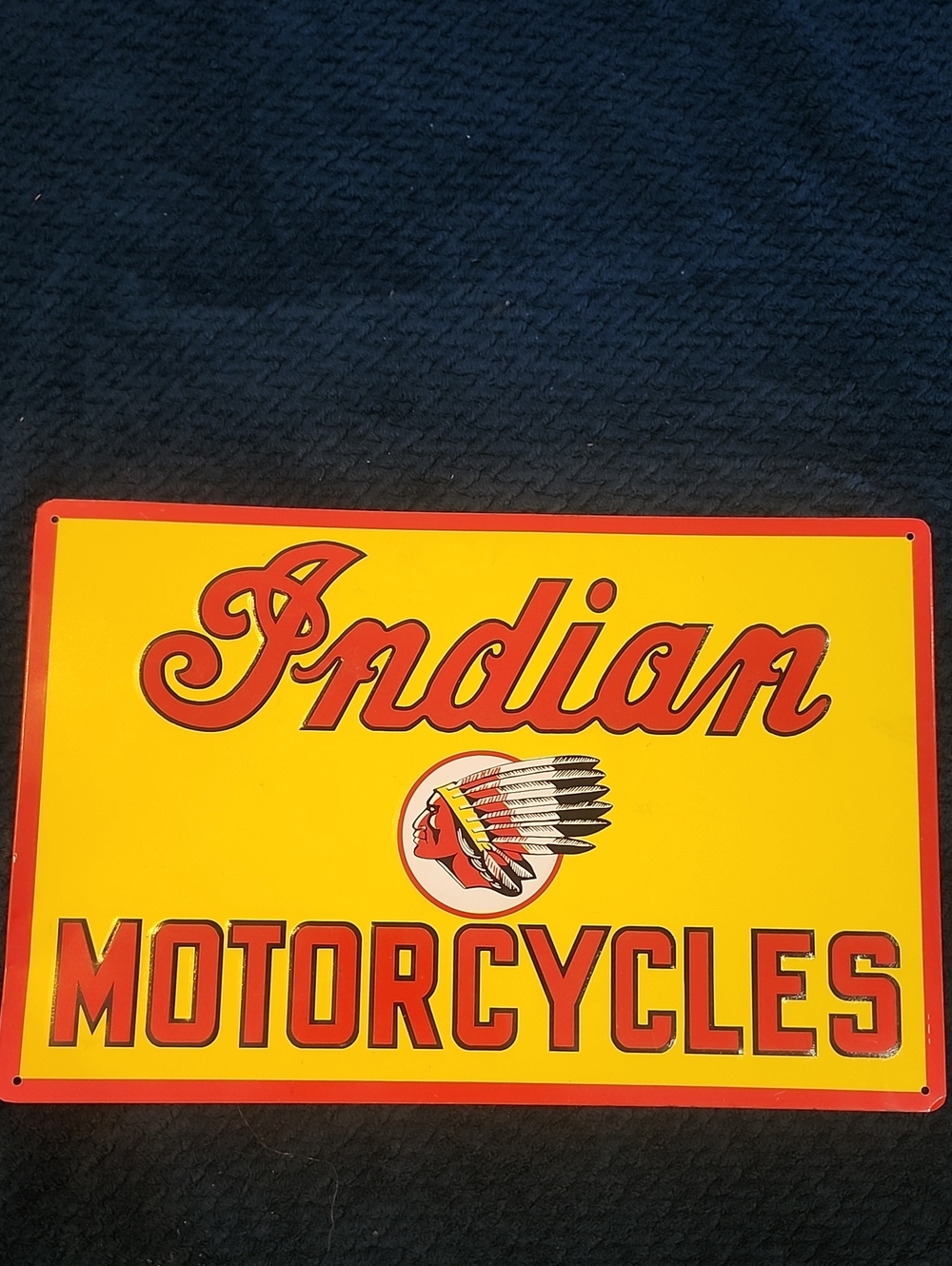 vintage-style Indian Motorcycles sign, likely made of porcelain or enamel